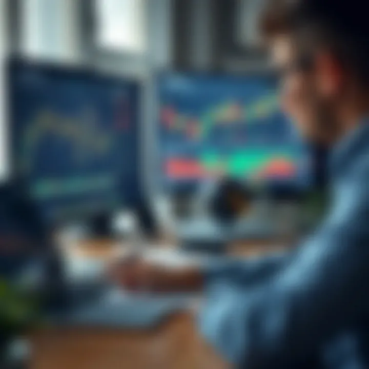 Person studying financial graphs on a computer with notes and a laptop